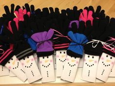 several pairs of gloves are tied together on a table with white and black polka dots