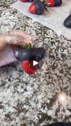 someone is cutting up some strawberries on a counter top with scissors and other items