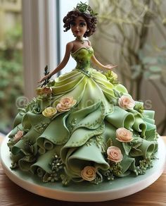 a cake made to look like a woman in a green dress with flowers on it