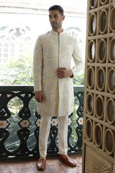 Ivory full sleeve sherwani with white and silver cutdana, sequin, thread, bead embroidery in floral abstract pattern. Paired with straight cut kurta and pant.
Components: 3
Pattern: Embroidery
Type Of Work: Thread, cutdana, bead, sequin
Neckline: Mandarin collar
Sleeve Type: Full sleeves
Fabric: Silk
Color: Ivory
Other Details: 
Front open sherwani
Occasion: Groom - Aza Fashions Open Sherwani, White Sherwani, Vikram Phadnis, Floral Abstract Pattern, Wedding Kurta For Men, Floral Abstract, Ivory Silk, Pattern Embroidery, Silk Embroidery