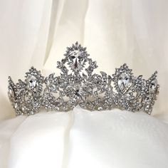 Our sophisticated bridal tiara features intricate detailing guaranteed to make an unforgettable statement on your big wedding day. With dazzling crystals and a refined elaborate motif, this glowing crystal tiara will complement a multitude of bridal hair styles on your special day. -Genuine crystals -Approximately 2.5in at the highest point x 11in across (6.4cm x 27.9cm) -Rhodium plated non-tarnish finish for brilliance Shown with earrings E168 Bridal Hair Styles, Glowing Crystal, Custom Signature, Crystal Tiara, Crystal Tiaras, Luxury Bridal, Big Wedding, Bridal Tiara, Bridal Headpieces