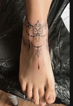 a woman's foot with a tattoo on it