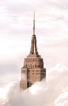 the empire building is surrounded by clouds in new york city