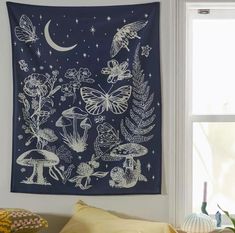 a tapestry hanging on the wall above a bed