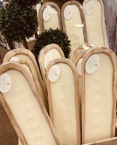 several mattresses are in a box on the floor next to a potted plant