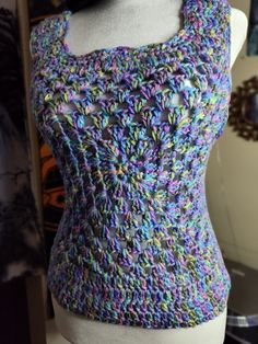 a mannequin wearing a purple and blue knitted top