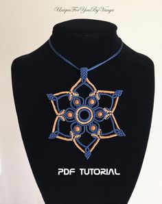 a black mannequin with an embroidered necklace on it