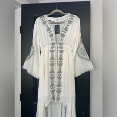 Boho Style Dress, Adjustable Tie Waist, High/Low Hem And Bell Sleeves. Color Is Not A Pure White, More Of A Slight Off-White. Fully Lined White Flowy V-neck Maxi Dress, White V-neck Boho Summer Dress, White Boho Maxi Dress For Beach Cover-up, White Maxi Dress For Beach Cover-up, White Long Maxi Dress For Beach Cover-up, Bohemian Off-white Maxi Dress For Day Out, Bohemian Off White Maxi Dress For Day Out, White Boho Maxi Dress Beach Cover-up, White Long Sleeve Summer Maxi Dress