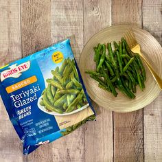 there is a bag of green beans next to a plate with some kind of food on it