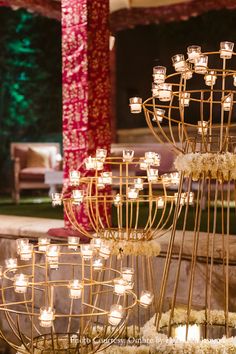 an arrangement of candles and flowers on display at a wedding