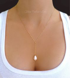 A delicate teardrop pearl adorns a sparkling chain to create a elegant and distinctive design A genuine ivory freshwater pearl teardrop - pearl is approx 11-13mm Chain is available in sterling silver or 14k gold filled chain - choose at checkout The length of the chain that goes around the neck not including the dangle section is shown at a 18" Choose the perfect length for you at checkout The pearl cascade is approximately an added 2 inches Necklace closes with a sterling silver or 14k gold fil Gold Key Necklace, Pearl Bridesmaid Jewelry, Pearl Lariat Necklace, Pearl Lariat, Curved Bar Necklace, Pearl Drop Necklace, Pearl Jewelry Wedding, Bridesmaid Gifts Jewelry, Y Necklace