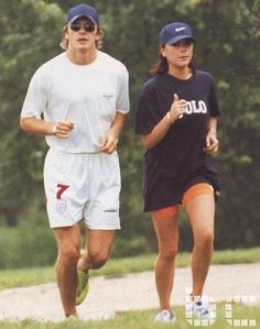 the man and woman are jogging in the park