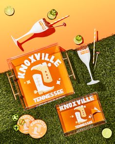 an advertisement for moxili's tennessee beer on the grass with orange and green decorations