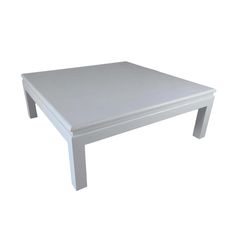 a white coffee table sitting on top of a white floor