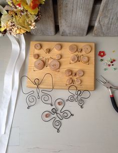 a wooden board with buttons and scissors on it