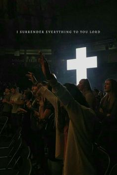 a group of people standing in front of a cross on top of a building with the words i surrender everything to you lord