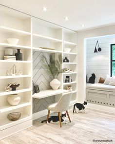 a white room with shelves, chairs and a desk in front of a large window