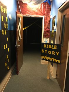 an open door leading into a room with a bible story sign on the front and side