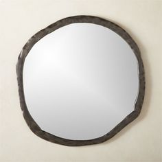 a round mirror hanging on the wall