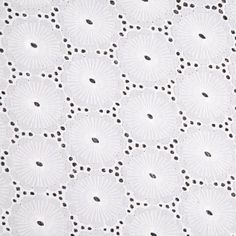 an image of white lace with black dots on the bottom and center, as seen from above