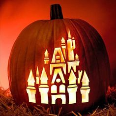 the cinderella castle pumpkin is lit up for halloween