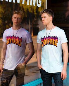 two young men standing in front of a store window with their hands in their pockets