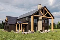 a large black and brown house in the middle of a field