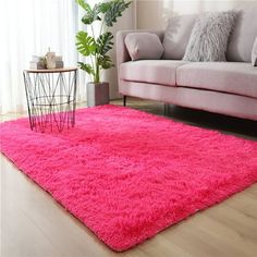 a living room with a pink rug on the floor