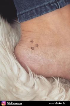 small dog paw tattoo on the ankle