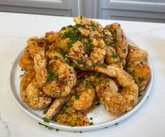 a white plate topped with chicken wings covered in parsley