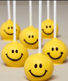 yellow cake pops with smiley faces on them