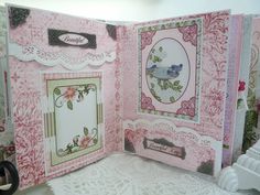 an open pink card with lace and flowers on it