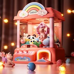 an assortment of stuffed animals and toys in front of a small toy carousel with lights