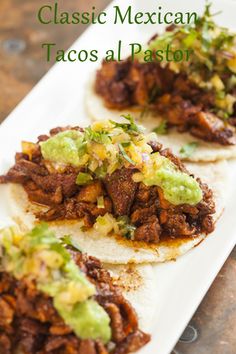 three tacos are sitting on a plate with the words classic mexican tacos al pastor