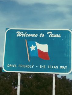 a welcome to texas sign with trees in the background