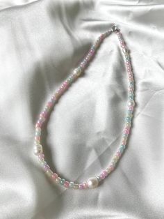 multi-color pastel glass beads strung along with 5 freshwater pearls. Pink Pearl Necklace With Colorful Round Beads, Pastel Beaded Necklaces With Round Beads, Multicolor Beaded Necklaces With Pearl Drop, Multicolor Beaded Necklace With Pearl Drop, Multicolor Pearl Drop Necklace, Multicolor Pearl Drop Necklaces With Round Beads, Multicolor Round Beads Necklace With Pearl Drop, Rainbow Round Beads Pearl Necklace, Pink Beaded Necklaces With Pearl Charm