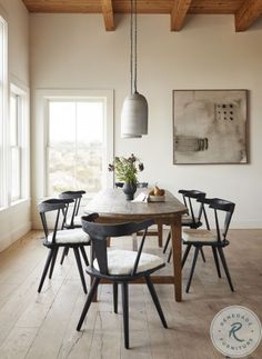 a dining room table with six chairs and a potted plant on top of it