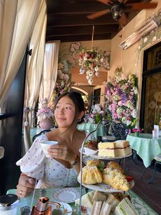 a woman sitting at a table with food on it