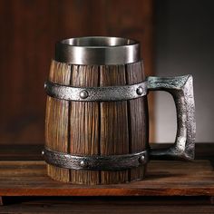 a wooden barrel with metal handles on a table