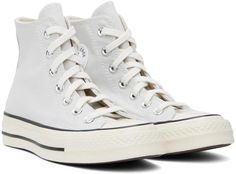 Converse.Gray Chuck 70 Vintage Canvas Sneakers.High-top 12 oz canvas sneakers in gray..· Rubber cap toe.· Lace-up closure.· Logo patch at inner side.· Eyelets at inner side.· Cushioned OrthoLite® footbed.· Rubberized logo patch at heel.· Treaded rubber sole.· Contrast stitching in white.Supplier color: Fossilized/Egret/Black.Upper: textile. Sole: rubber..Made in Viet Nam..241799F127080 Gray High-top Canvas Shoes, Gray High-top Canvas Shoes With Laces, Gray Lace-up Cotton Sneakers, Gray Low-top Cotton Sneakers, Lace-up High-top Cotton Sneakers With Rubber Toe Cap, Cotton Lace-up High-top Sneakers With Rubber Toe Cap, White Lace-up Sneakers With Canvas Lining, Converse High-top Sneakers With White Laces For Streetwear, White Sneakers With Canvas Lining For Streetwear