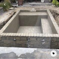 an unfinished pool in the middle of a yard