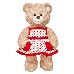 a brown teddy bear wearing a red and white dress