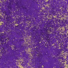 an old purple and yellow wall with some paint splattered on the surface,