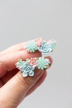 Dive into the world of unique handcrafted jewelry with our Succulent Cuff Earrings. Each pair is lovingly handcrafted with the intricate details of succulent plants in mind, made entirely from high-quality polymer clay. Every petal is hand-modeled, ensuring that each pair of earrings is truly one of a kind. Unique Handcrafted Jewelry, Hand Model, Cuff Earrings, Accessories Unique, Planting Succulents, Nature Beauty, Polymer Clay, Cuff, Green