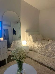 a bedroom with a bed, dresser and mirror in it's centerpieces