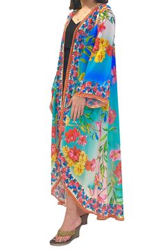 This light and airy duster is ready for tan lines and vacation vibes with its flowy longline silhouette and ombré flower print. 52" length (size OS)
 Open front Short sleeves 100% polyester
 Hand wash cold, lay flat to dry
 Imported Model stats: 5'10", 32" bust, 25" waist, 36" hip. Model is wearing size OS. Blue Floral Print Cover-up For Spring, Blue Floral Print Spring Cover-up, Spring Blue Floral Print Cover-up, Flowy Blue Cover-up With Floral Print, Hawaiian Floral Print Spring Cover-up, Spring Long Pool Cover-up, Long Spring Pool Cover-up, Long Tropical Cover-up For Spring, Vacation Vibes