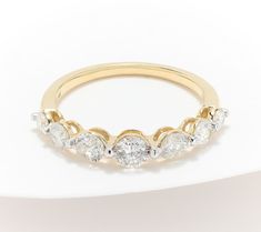 a yellow gold ring with five diamonds