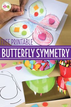 the printable butterfly symmetry is on top of a table with paper and crayons