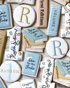 many different types of cookies with letters and names on them, all decorated like books