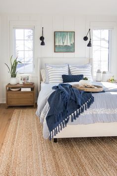 a bedroom with white walls and wood floors